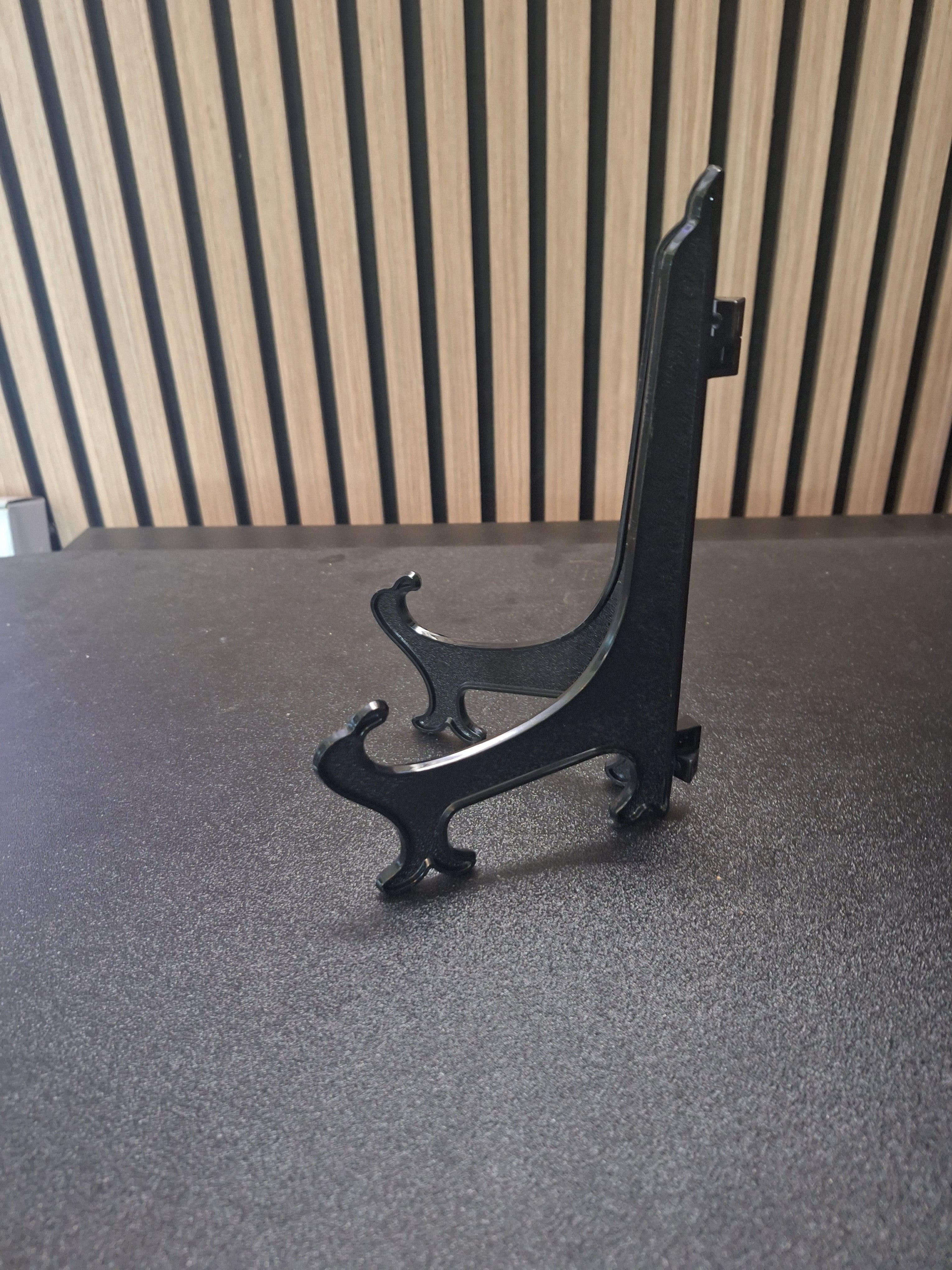 side view of 20cm black darts card display stand showing support design