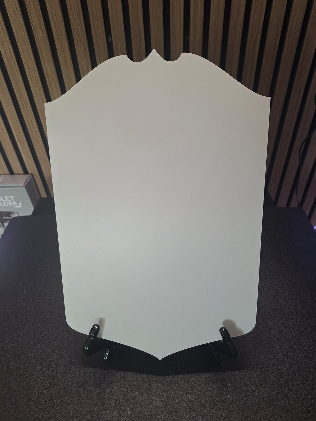 Player card display stand holding oversized darts player card front view